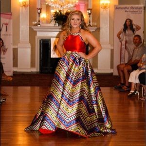 Red romper with detachable skirt and gold chain halter neck